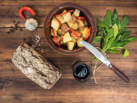 Still life of vegetables, baked potatoes with meat, vegetables, bread and glass of red wine on the background of wooden . Rural Breakfast, top view. Assorted of vegetables.の写真素材