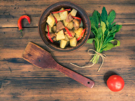 Still life of vegetables, baked potatoes with meat, vegetables, pepper on the background of wooden table. Rural Breakfast, top view. Assorted of vegetables.の写真素材