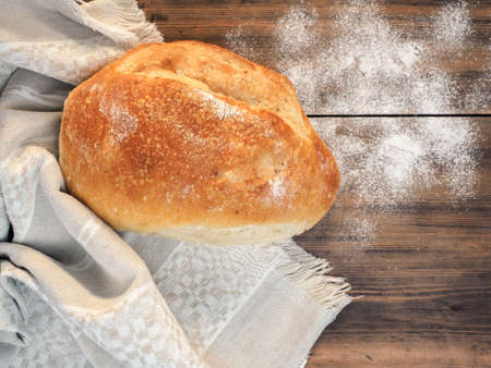 Still life with bread on the background of the tablecloth and old wood. Scattered on the table...