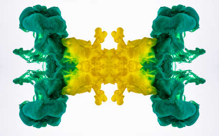 Mixing of yellow and green acrylic pigments in liquid. Colour ink in water, abstract pattern....