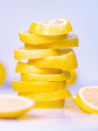 Pile of juicy lemon slices on light background, close up view.の写真素材