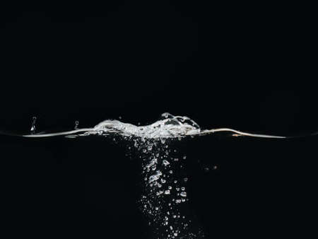 Water bubbles and rippling water surface isolated on black background, close up view. Liquid splashing. Abstract background for overlays design, screen blending mode layerの写真素材