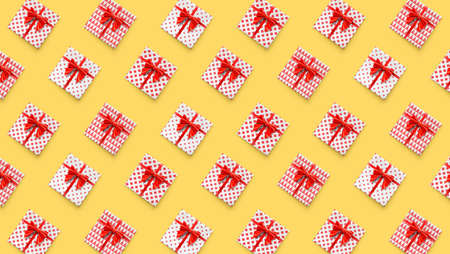 Present boxes, abstract pattern. Gift boxes with red ribbon and bow tie isolated on yellow...