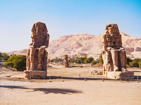 Ruined androsphinx statues near Hatshepsut temple, long view. High mountain on horizon. Photographed in Dayr al Bahri, Luxor. Selective soft focus. Blurred backgroundの写真素材