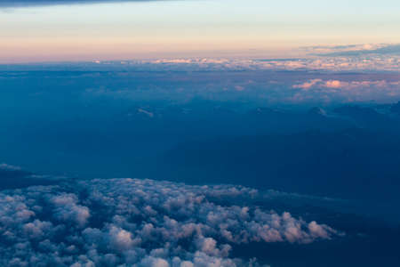 white and colored clouds from airplaneの写真素材