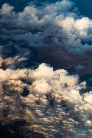 white and colored clouds from airplane