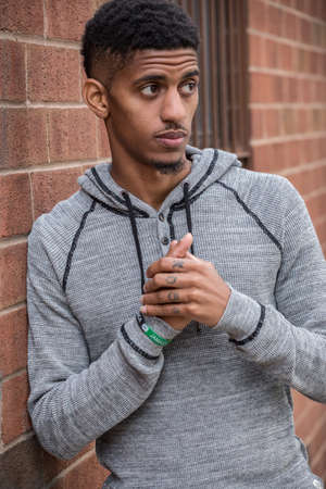 A portrait of a young man, pensively standing in New York Cityの写真素材