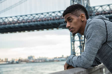 A portrait of a young man, pensively standing in New York Cityの写真素材
