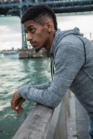 A closeup portrait of a young, black man in New York City. Shot during the Autumn of 2016.の写真素材