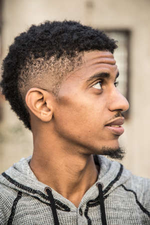 A portrait of a young man, pensively standing in New York Cityの写真素材