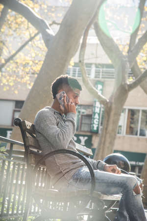 A young, black hipster poses for a candid photograph in NYC. Shot during the autumn of 2016.の写真素材