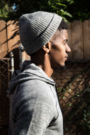 A portrait of a young man, pensively standing in New York City