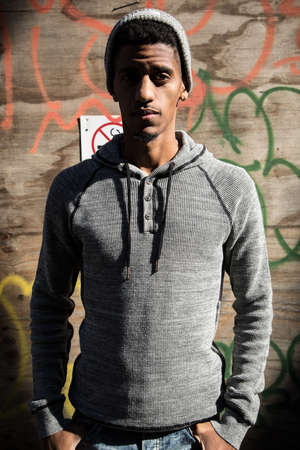 A portrait of a young hipster posing infront of a wall of Graffiti. Shot in Brooklyn, New York City during the Autumn of 2016.の写真素材