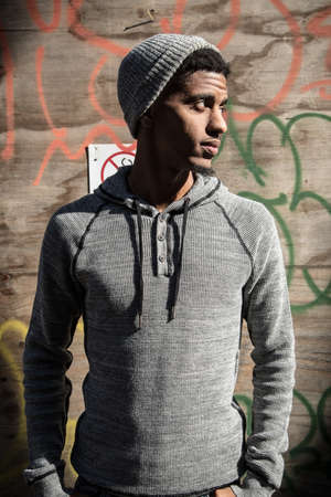 A portrait of a young man, pensively standing in New York Cityの写真素材