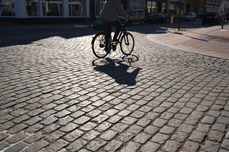 Cyclist on cobblestoneの写真素材