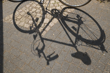 A bicycle casts a shadowの写真素材