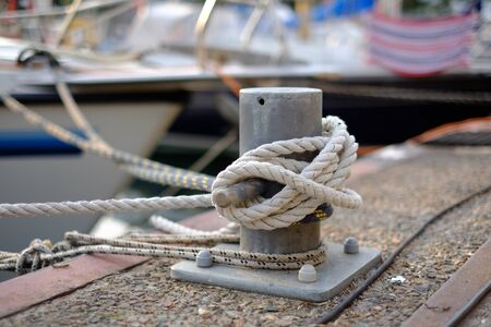 Bollard with mooring knots on the jetty