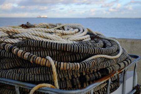 Ropes on the harbor overlooking the seaの写真素材