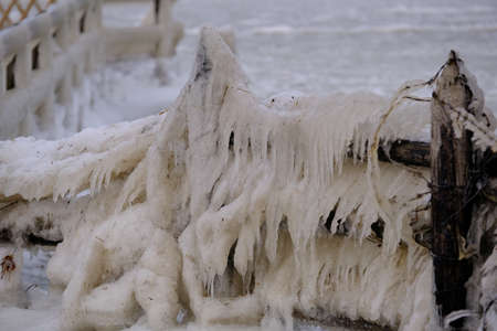 Icicles on the bank of a lakeの写真素材