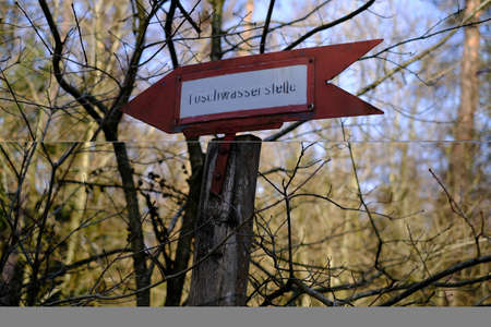 Illegible sign to the extinguishing water point in the forestの写真素材