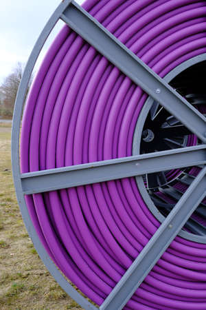 Cable drum with purple protective tubeの写真素材