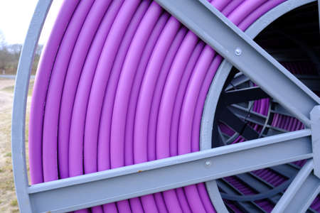 Cable drum with purple protective tubeの写真素材