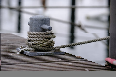 Bollard on the landing stage with cordage