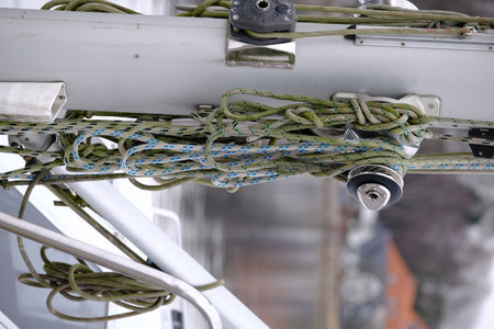 Rigging hangs untidily on the mast of a sailing shipの写真素材