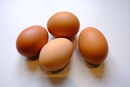 Four brown chicken eggs in the kitchen