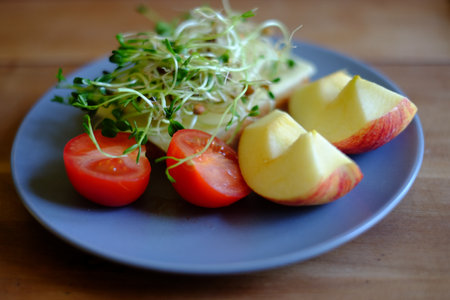 Healthy breakfast with apple, cheese and tomatoの写真素材