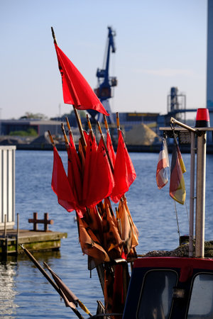 Red flag in the harbor on a cutterの写真素材