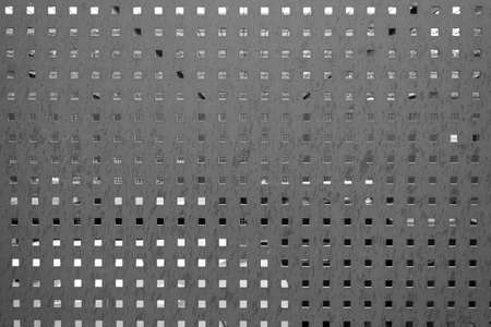 Perforated plate at a garbage collection point serves as a privacy screenの写真素材