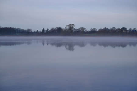 Fog lies on the lakeの写真素材