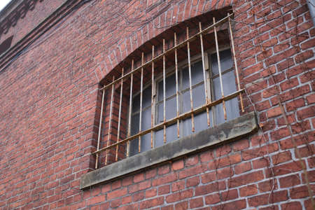 Metal grille in front of a windowの写真素材