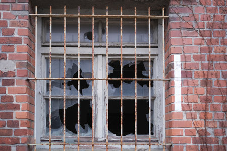 Barred window in an old brick building