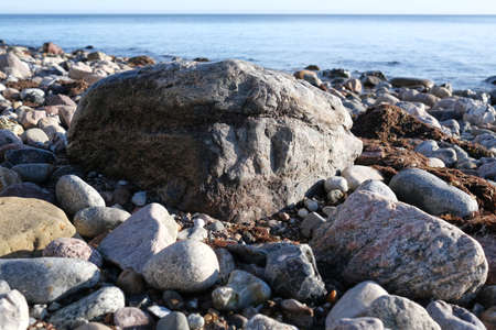 A large stone on the shore of the Baltic sea. Close-up.の写真素材