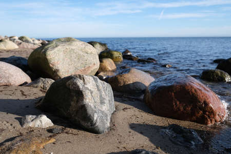 Rocky beach with a cliff on the beachの写真素材
