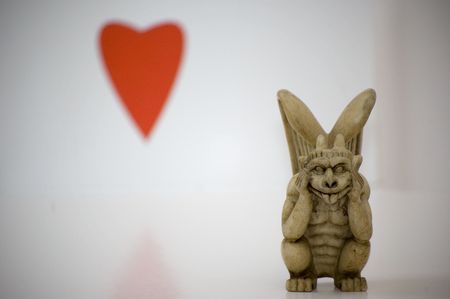 Gargoyle with red heart in backgroundの写真素材