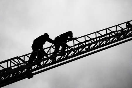 Firefighter and child on ladderのeditorial素材