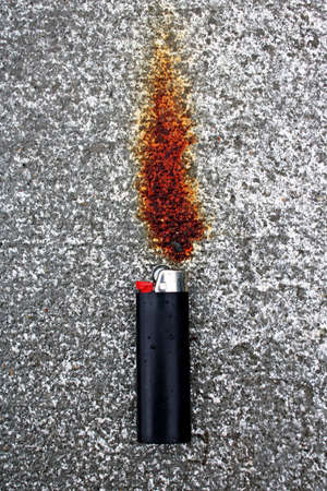 this rust stain on cement looks like a flame with that black lighter below it