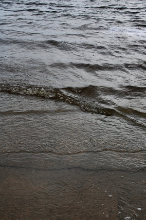 textural details of tidal water washing over old cementの写真素材