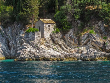 Tiny Ancient Building in Rocky Coastline of Corfu Greece