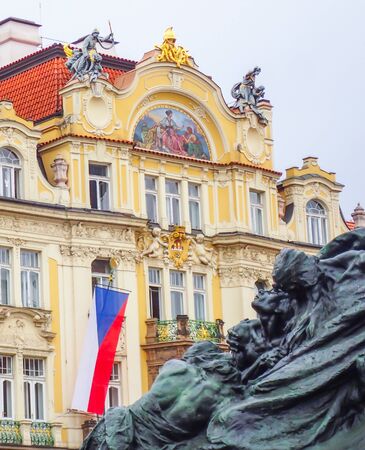 Statue Building and Flag Layers of History in Town Square Pragueの写真素材