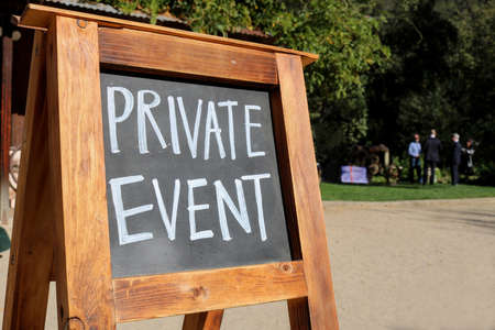 Chalkboard Sign on Wooden Stand Announces Private Eventの写真素材