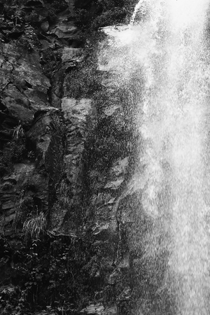 Black and White Close Up Waterfall on Wet Rocky Cliff