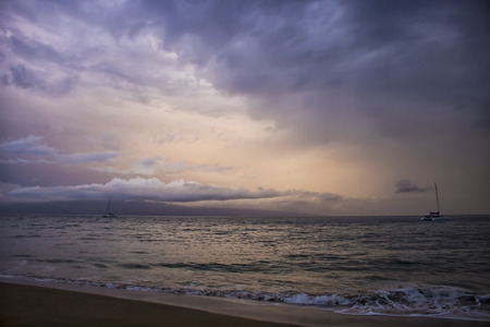 Dramatic clouds in sunset seascape as storm hurricane approaches islandの写真素材