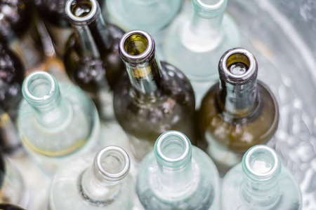 Empty wine bottles in a metal bucket.の写真素材