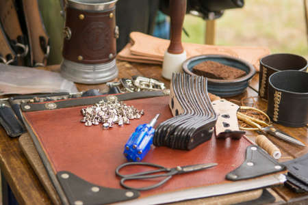 Tools a screws for working with leather on a work table.の写真素材