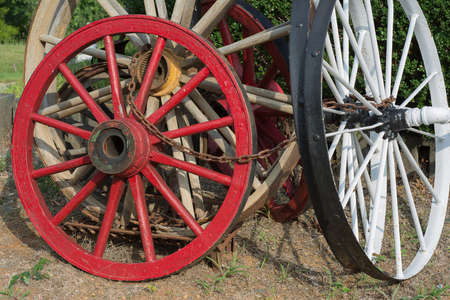 Old wagon wheels chained together.の写真素材