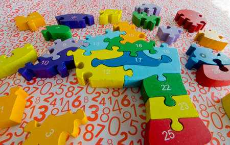 puzzles and colored figures with numbers and letters used in occupational therapy, for...